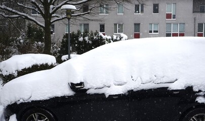 Black car covered in snow