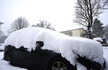 Black car covered in snow