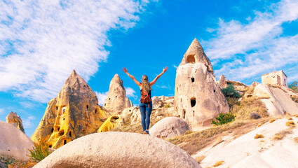 happy woman arms up enjoying spectacular view of Cappadocia landscape, travel, tour tourism in Turkey