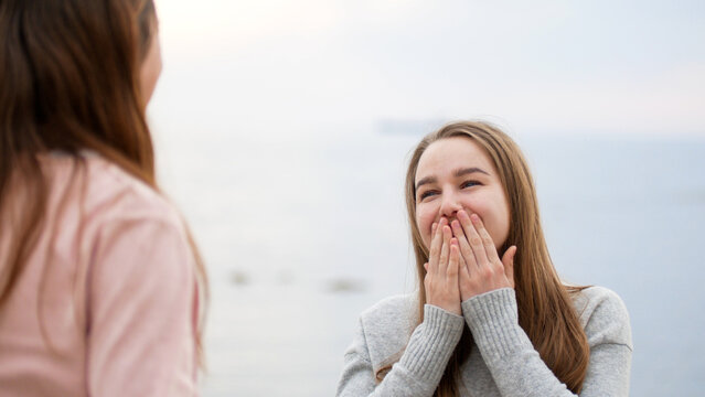 Young woman reacting with surprised happy expression