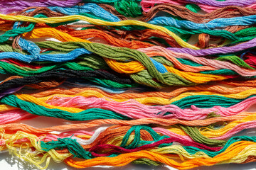 multi-colored threads for embroidery, floss, Mixed colorful texture of interlaced threads