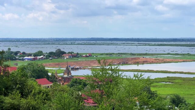 Viewpoint of a flooded fishing village near the Krahom Temple, Cambodia. From the mountain Krahom (Pnom Krom) overlooking the lake Tonlesap. Houses are built on high stilts. Rainy season. 4К