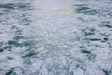 Glittering ice surface reflects winter sunlight in a serene skating rink at twilight
