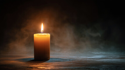 Candle flame illuminating dark background with smoky atmosphere  