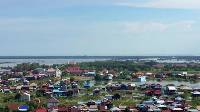 Viewpoint of a flooded fishing village near the Krahom Temple, Cambodia. From the mountain Krahom (Pnom Krom) overlooking the lake Tonlesap. Houses are built on high stilts. Rainy season. 4К