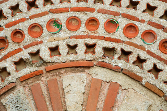 Detailed view of the intricate Byzantine opus mixtum" masonry and decorative ceramic inserts on the exterior facade of the historic St. Paraskeva Church in Nessebar, Bulgaria, UNESCO