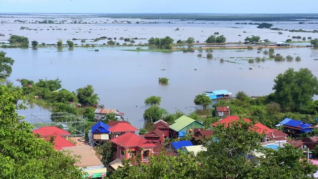 Viewpoint of a flooded fishing village near the Krahom Temple, Cambodia. From the mountain Krahom (Pnom Krom) overlooking the lake Tonlesap. Houses are built on high stilts. Rainy season. 4К