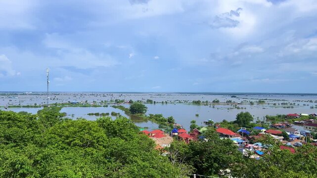Viewpoint of a flooded fishing village near the Krahom Temple, Cambodia. From the mountain Krahom (Pnom Krom) overlooking the lake Tonlesap. Houses are built on high stilts. Rainy season. 4К