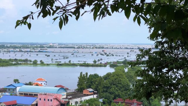 Viewpoint of a flooded fishing village near the Krahom Temple, Cambodia. From the mountain Krahom (Pnom Krom) overlooking the lake Tonlesap. Houses are built on high stilts. Rainy season. 4К