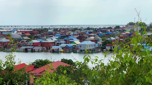 Viewpoint of a flooded fishing village near the Krahom Temple, Cambodia. From the mountain Krahom (Pnom Krom) overlooking the lake Tonlesap. Houses are built on high stilts. Rainy season. 4К