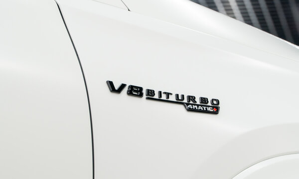 Close-up of V8 biturbo 4matic emblem on white Mercedes Benz GLS 580 SUV. Mercedes-AMG GLS 63. Mercedes V8 Biturbo performance logo on the fender of the car. 