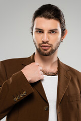 Stylish man exuding confidence in a sleek brown suit and casual t shirt during a stunning photoshoot