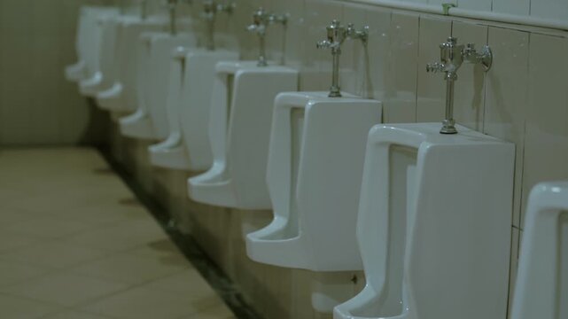 Clean and modern row of urinals in a public restroom