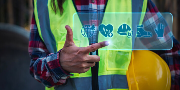 Worker holding hard hat with EHS and safety management digital for industrial workplace protection and occupational health compliance, health and safety, quality management,