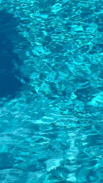 Vertical shot of clear blue pool water