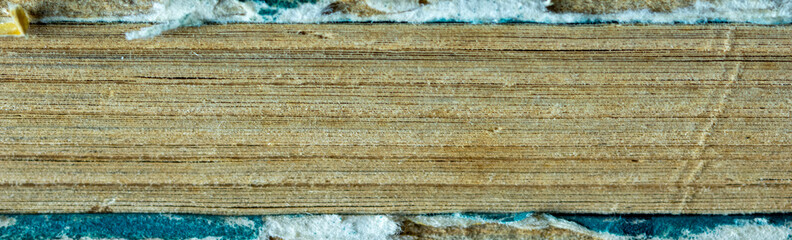 Detailed plywood cross section showing horizontal wood layers and fibrous edges as natural background.