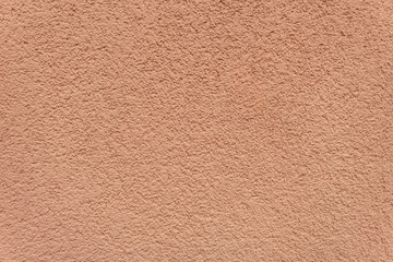 Pink stucco wall with rough texture. Plastered surface background. © Anastasiia