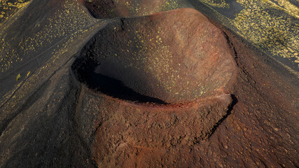 Aerial view of the southern crater of Mount Etna in Sicily, Southern Italy. It is the highest active volcano in Europe. It is a beautiful summer day. Close-up from above of a volcanic crater. © Stefano Tammaro
