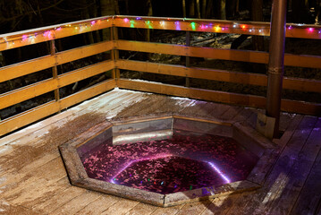 Intimate scene of couple relaxing in heated outdoor spa during twilight