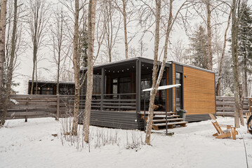 Quiet woodland sanctuary with elevated deck amidst snowy scenery