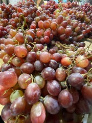 Close up of raw organic sweet red grapes background.