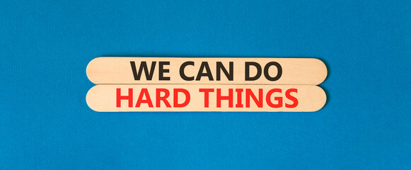 Support, help we can do hard things symbol. Concept words We can do hard things on beautiful wooden sticks. Beautiful blue background. Business we can do hard things concept. Copy space.
