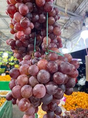 Close up of raw organic sweet red grapes background.