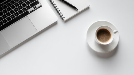 Minimalist workspace with laptop coffee cup notepad and pen on white
