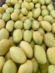Fresh yellow mangoes for sale at a street market in Indonesia
