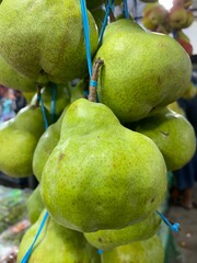 Close up photo of many green pears. Fresh fruits are harvested and ready for sale. Healthy eating lifestyle concept. Juicy ingredients are good for diet.