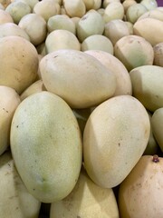 Fresh yellow mangoes for sale at a street market in Indonesia