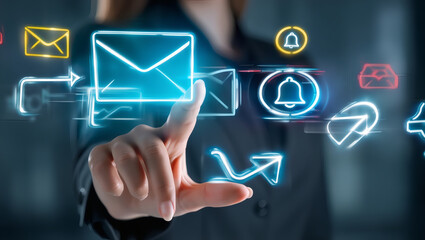 Businesswoman interacting with futuristic holographic communication icons for email and notification management