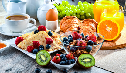Breakfast served with coffee, juice, croissants and fruits