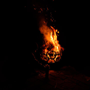 A cozy scene unfolds as bright flames dance, providing warmth and light in the dark