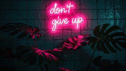 Inspirational neon sign with don't give up message and tropical leaves