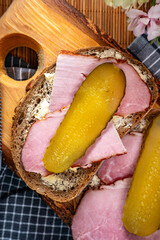 Sandwich with ham, cheese and pickled cucumber.