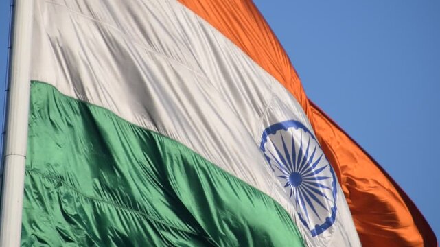 India flag flying high at Connaught Place with pride with plain white background, India flag fluttering, Indian Flag on Independence Day and Republic Day of India, tilt up shot, Har Ghar Tiranga