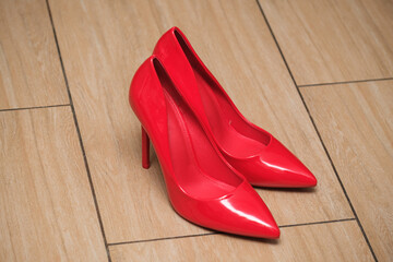 red women's stiletto heels on the floor