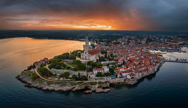 Rovinj, Croatia - Aerial panoramic view of the old town of Rovinj with Church of St. Euphemia and dramatic golden and blue sunrise on a summer morning in Istria, Croatia by the Adriatic sea