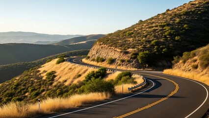Winding road through dry hillside landscape.