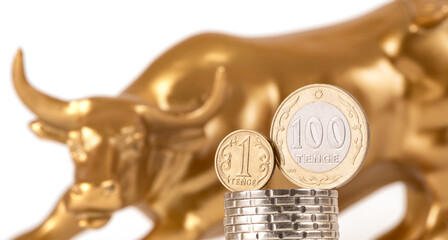 A symbol of optimism on the stock exchange, as well as wealth and greed - a golden bull (calf) and coins of 1 and 100 Kazakhstani tenge
