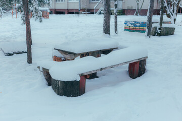 Serene Winter Landscape Showcasing Handpainted Barrels Supporting Frozen Picnic Area In Quiet Neighborhood