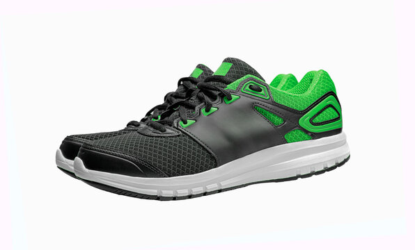 A pair of black and neon green athletic running shoes is isolated on a solid white background.