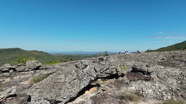 Drone aerial footage of Hin Pum stone formations at Phu Pha Phueng viewpoint in Kalasin UNESCO Global Geopark, Thailand, showcasing unique geology, natural landscape, and scenic horizon.
