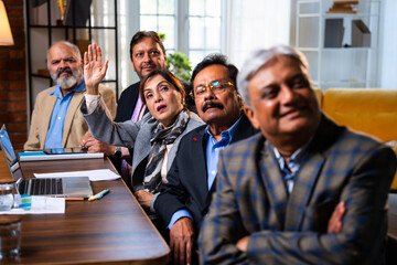 Senior Indian executives applauding successful business presentation in modern corporate office