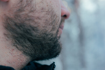 Authenic Street Portrait Capturing Pensive Individual With Visible Breath In Winter Setting