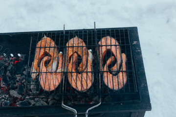 Charcoal Grilled Salmon By Snowy Lakes, Rustic Winter Barbecue Featuring Sizzling Salmon Steaks Outdoors