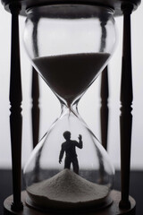 Silhouette of a man and hourglass.