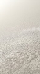 Fototapeta premium Close up view of a textured light colored fabric surface with diagonal lines and soft lighting