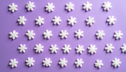 Pastel Snowflake Pattern on Purple Background for Winter Holidays.